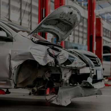 damaged car in a body shop ready for frame straightening