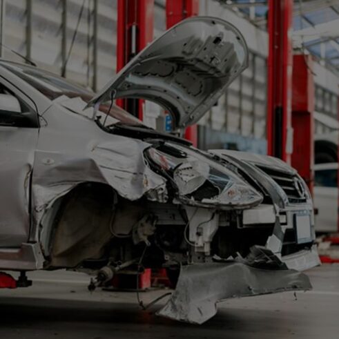 damaged car in a body shop ready for frame straightening